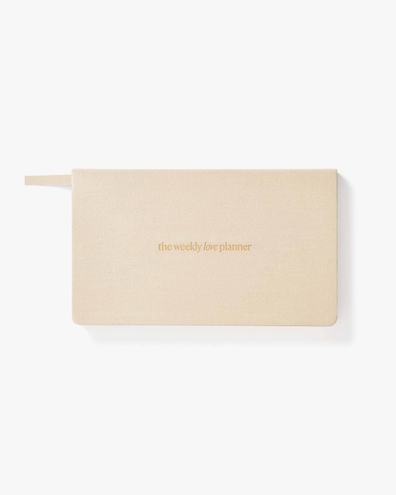 Beige planner with 'the weekly life planner' text on a white background